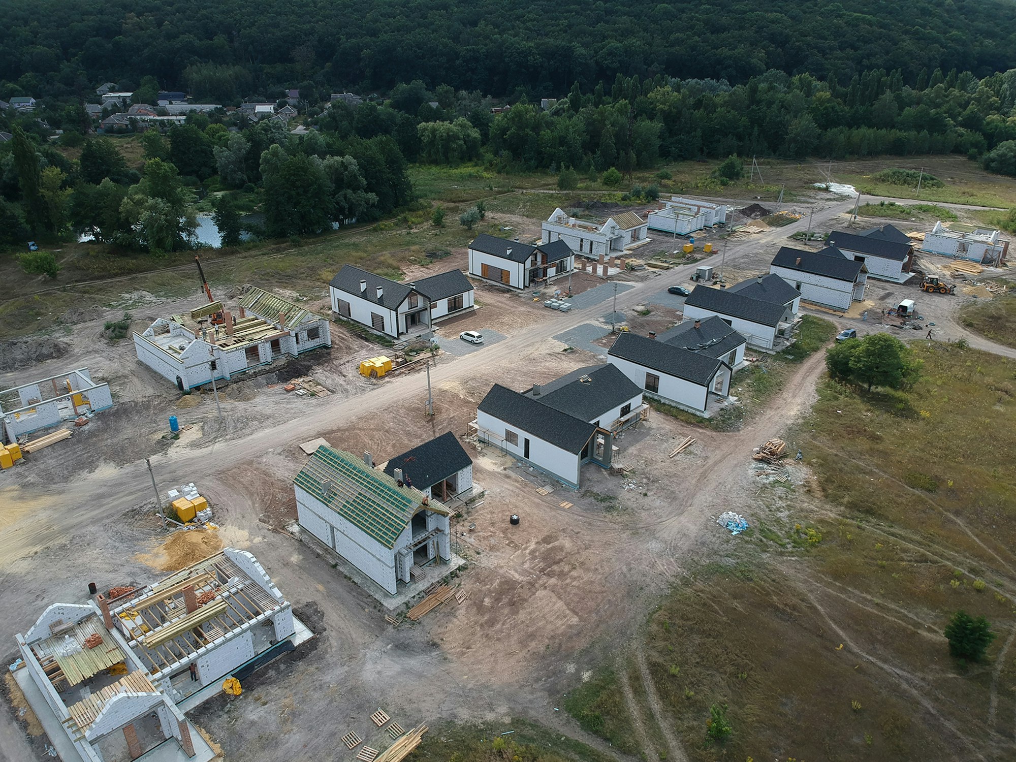 New private housing development construction in rural countryside aerial view