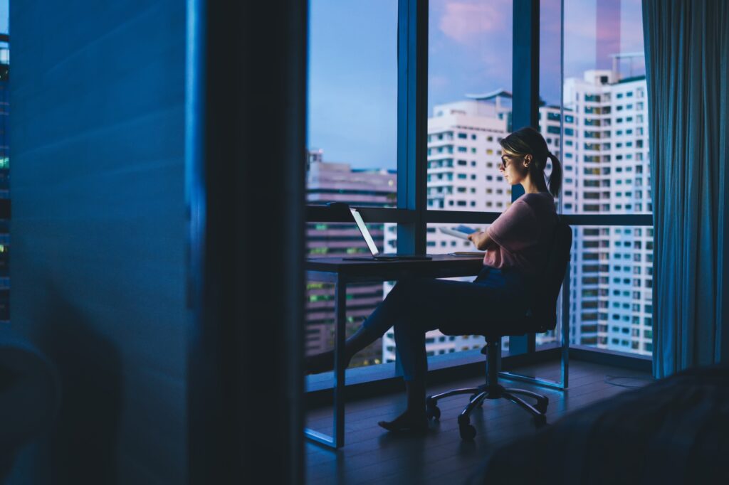 Serious woman with folded hands on chair