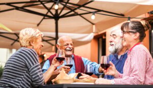 Group of old people eating and drinking outdoor